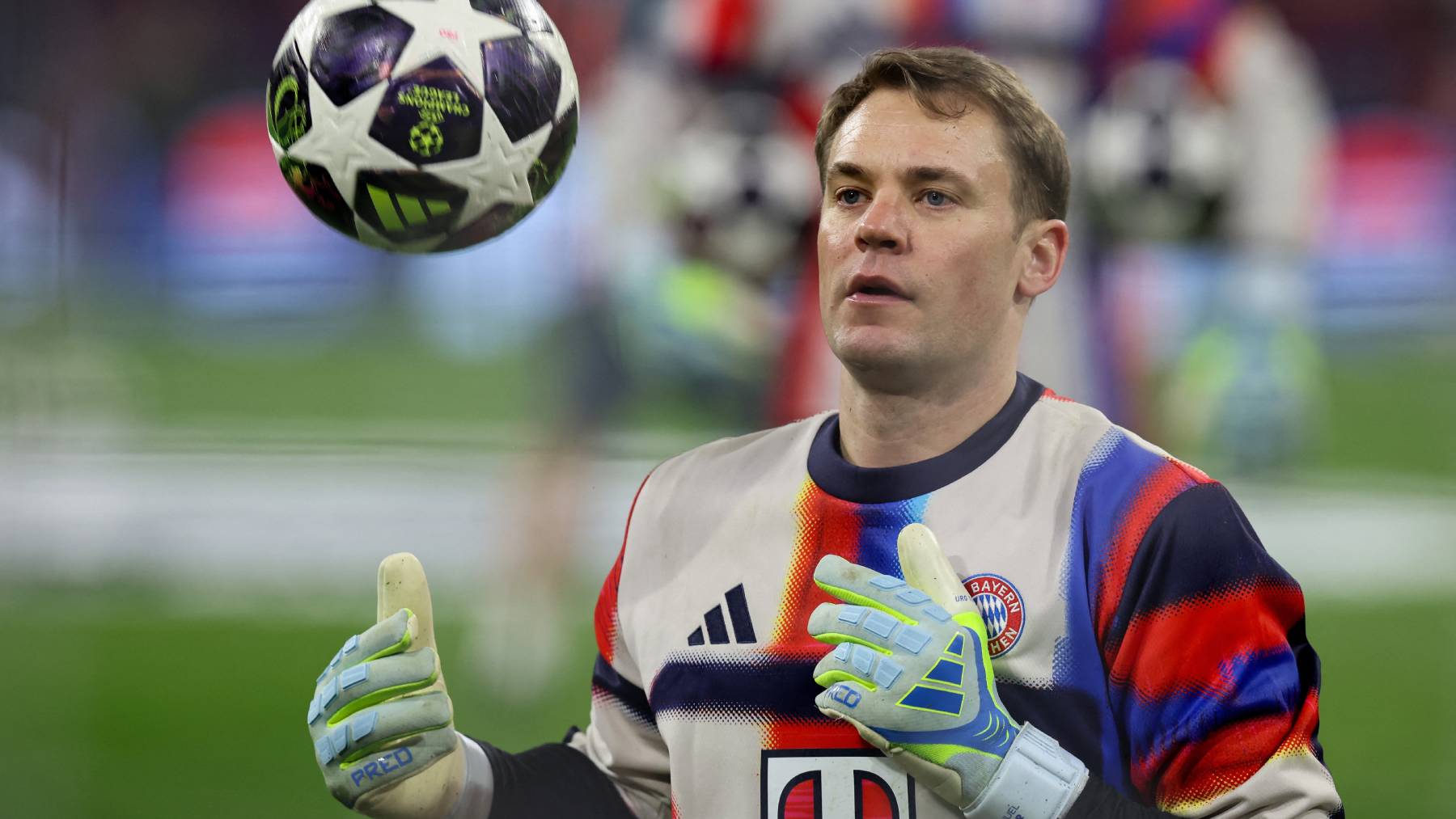 FILES) Bayern Munich's German goalkeeper #01 Manuel Neuer catches the ball during the warm up prior to the UEFA Champions League quarter-final second leg football match between FC Bayern Munich and Real Madrid in Munich, southern Germany, on April 15, 2026. Bayern Munich veteran Manuel Neuer announced on May 15, 2026 that he has extended his contract at the German champions by one year until 2027. The 40-year-old goalkeeper's deal was set to expire in the summer but he will stay on in Munich for what will be a 16th year at the Bavarian giants.