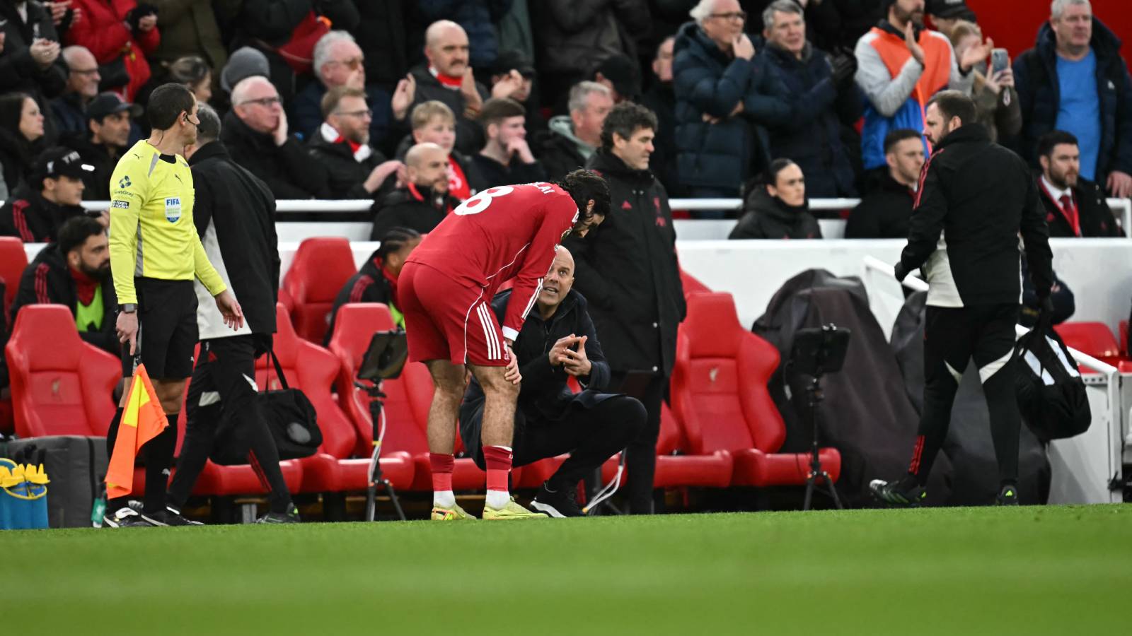 Liverpool's Dutch manager Arne Slot gives instructions to Liverpool's Hungarian midfielder #08 Dominik Szoboszlai during the English Premier League football match between Liverpool and Brighton and Hove Albion at Anfield in Liverpool, north west England on December 13, 2025.