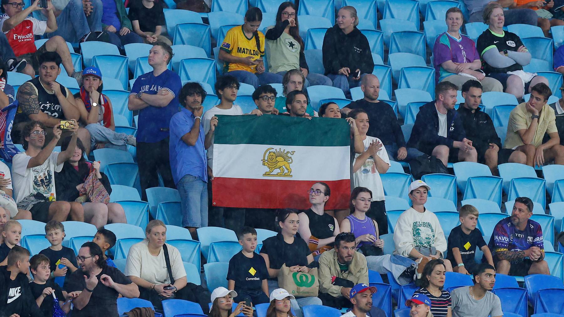 A group of Iranian supporters display a Pahlavi‑era flag during the AFC Women’s Asian Cup Australia 2026 match between Iran and the Philippines on the Gold Coast on March 8, 2026.